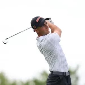 A college golfer from the University of Denver finishing his swing.
