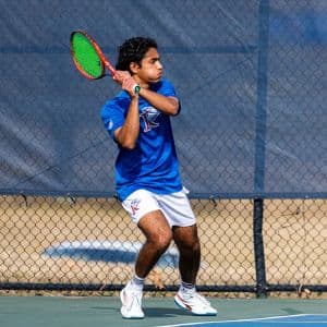 A college tennis player from King University playing on a hard court.