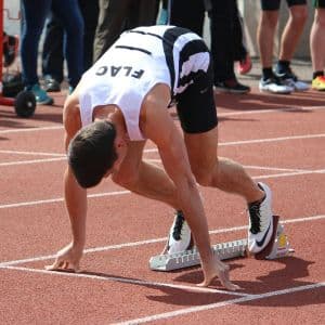 A college track & field athlete ready to start a race.