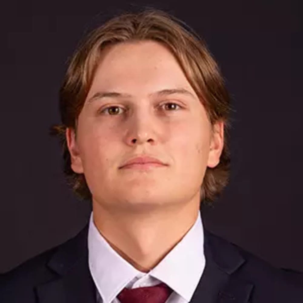 Jari Stacher – Keene State College, NCAA DIII Headshot of Jari Stacher in a suit.
