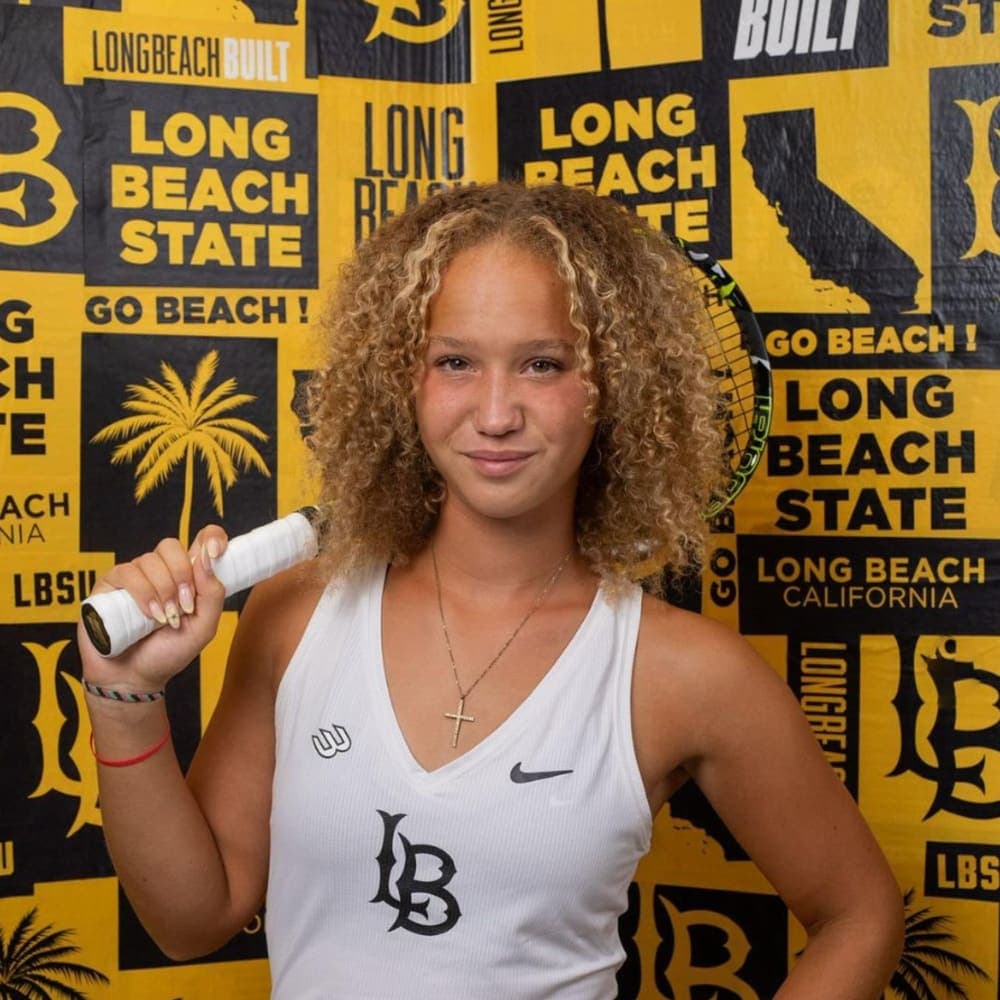 Johanna Hiesmair – Long Beach State University, NCAA DI Headshot of a female college tennis player holding her tennis racket in her right hand.