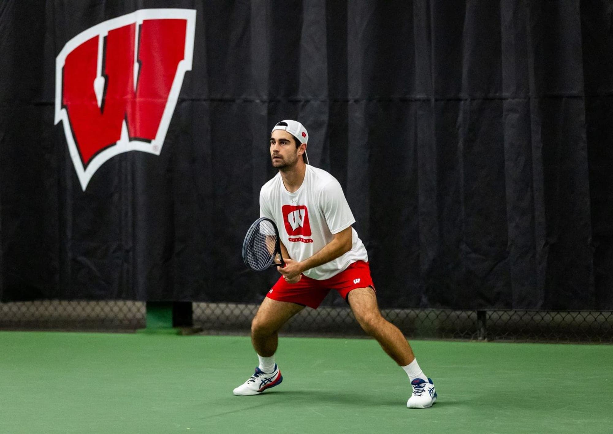 Gabriel Huber playing college tennis at the University of Wisconsin-Madison