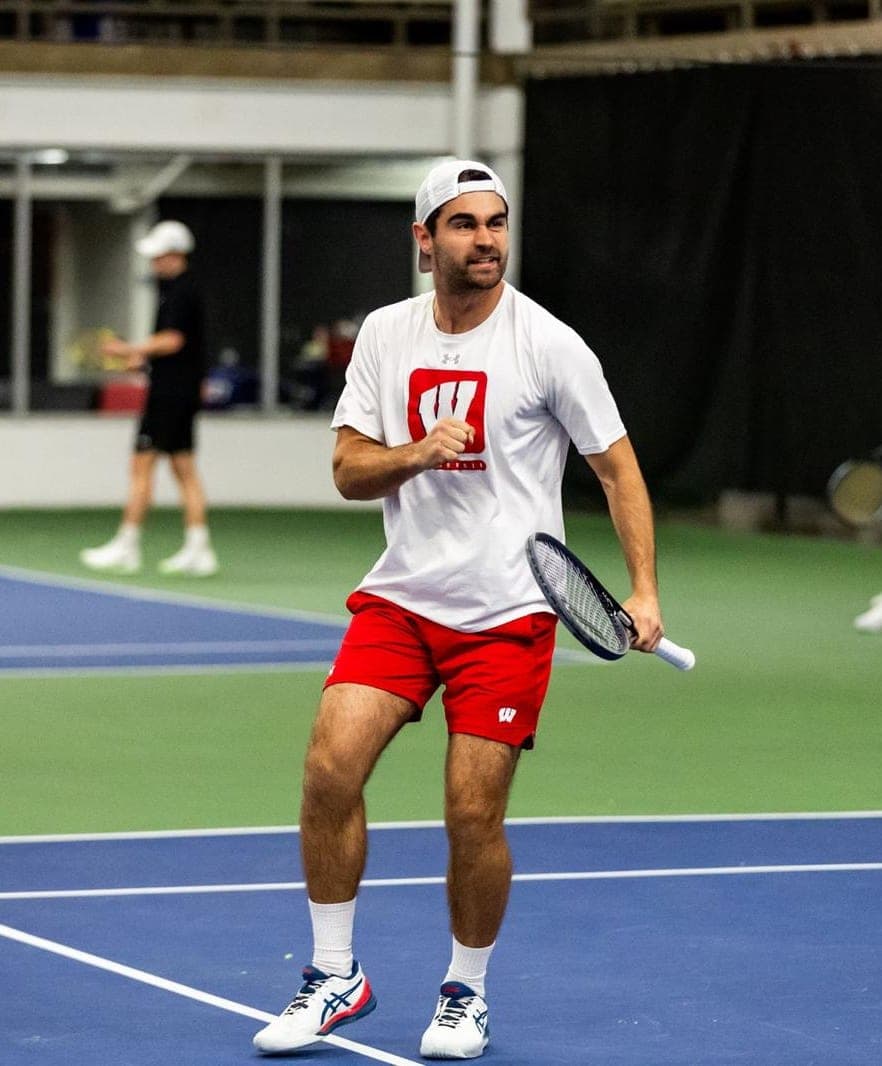 College Tennis Player Celebrating a Point | Smarthlete Male college tennis player celebrating his point with a closed fist.