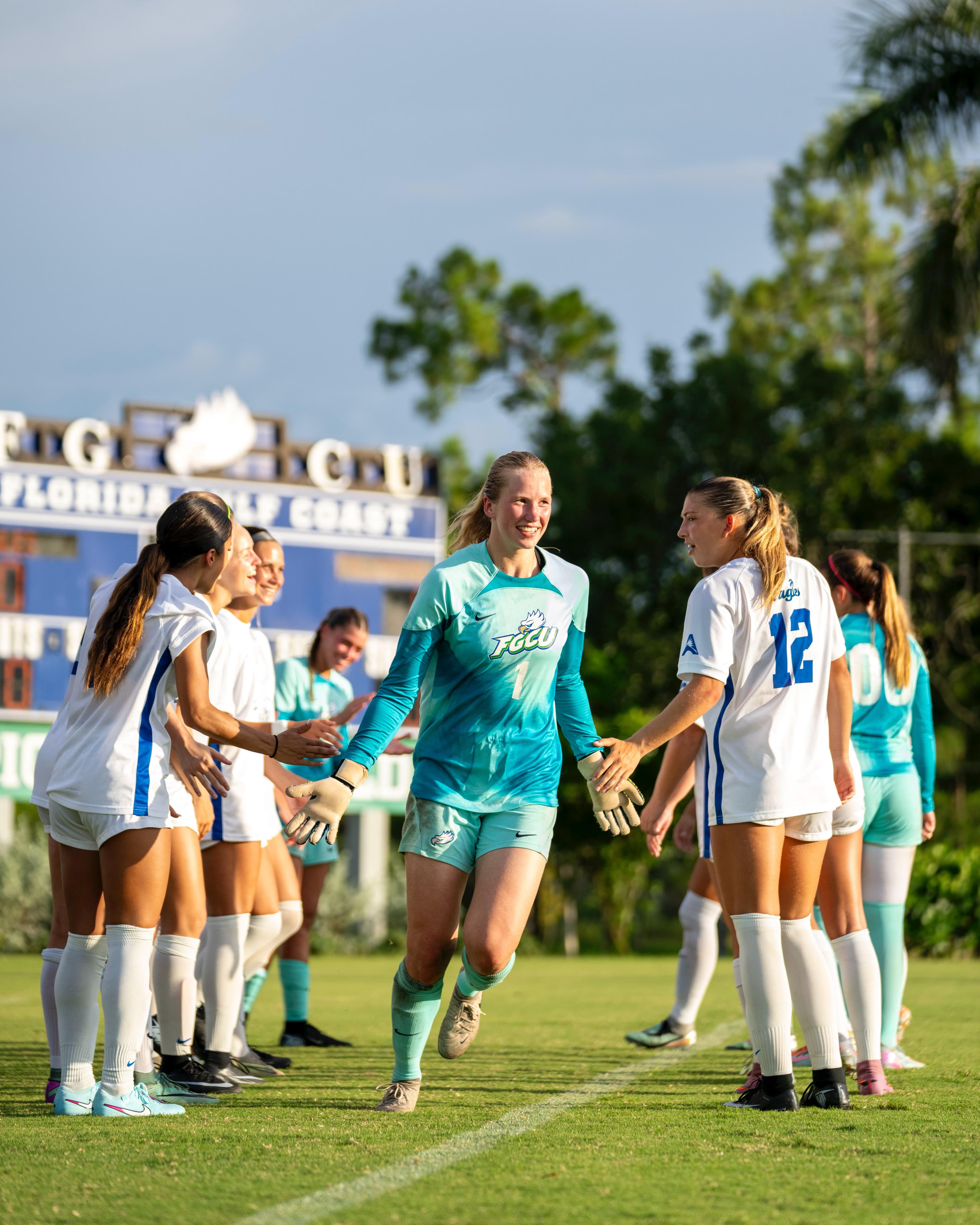 College Soccer Goalkeeper Madara Matrevica | Smarthlete College soccer goalkeeper Madara Matrevica shaking hands with her teammates before a college soccer game.
