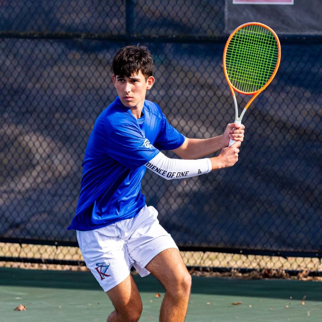 College Tennis Player on Hard Court | King University A college tennis player from King University playing on a hard court.