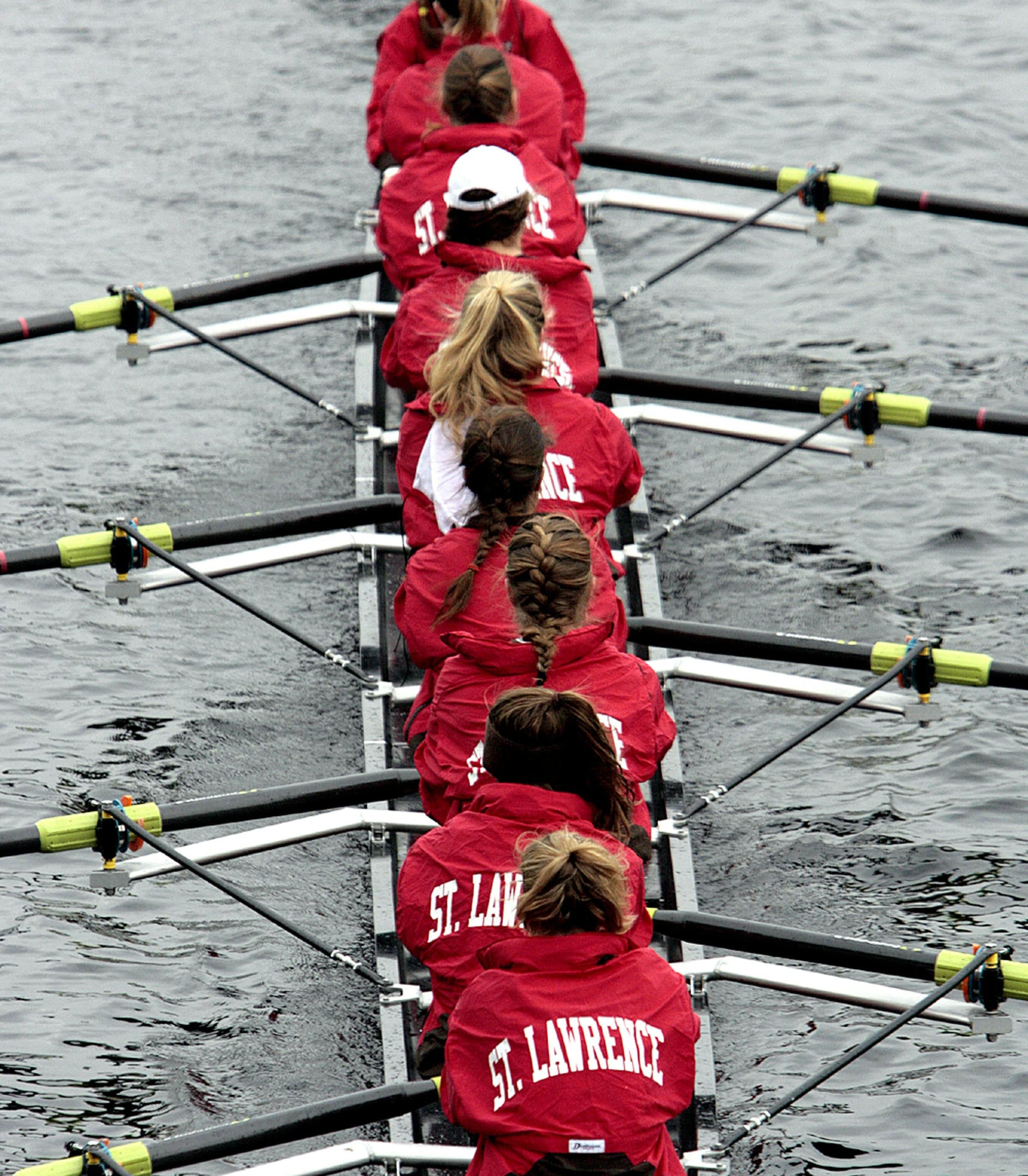 St. Lawrence Women's Rowing Crew | College Rowing Women's rowing crew from St. Lawrence in red jackets, perfectly synchronized on the water.