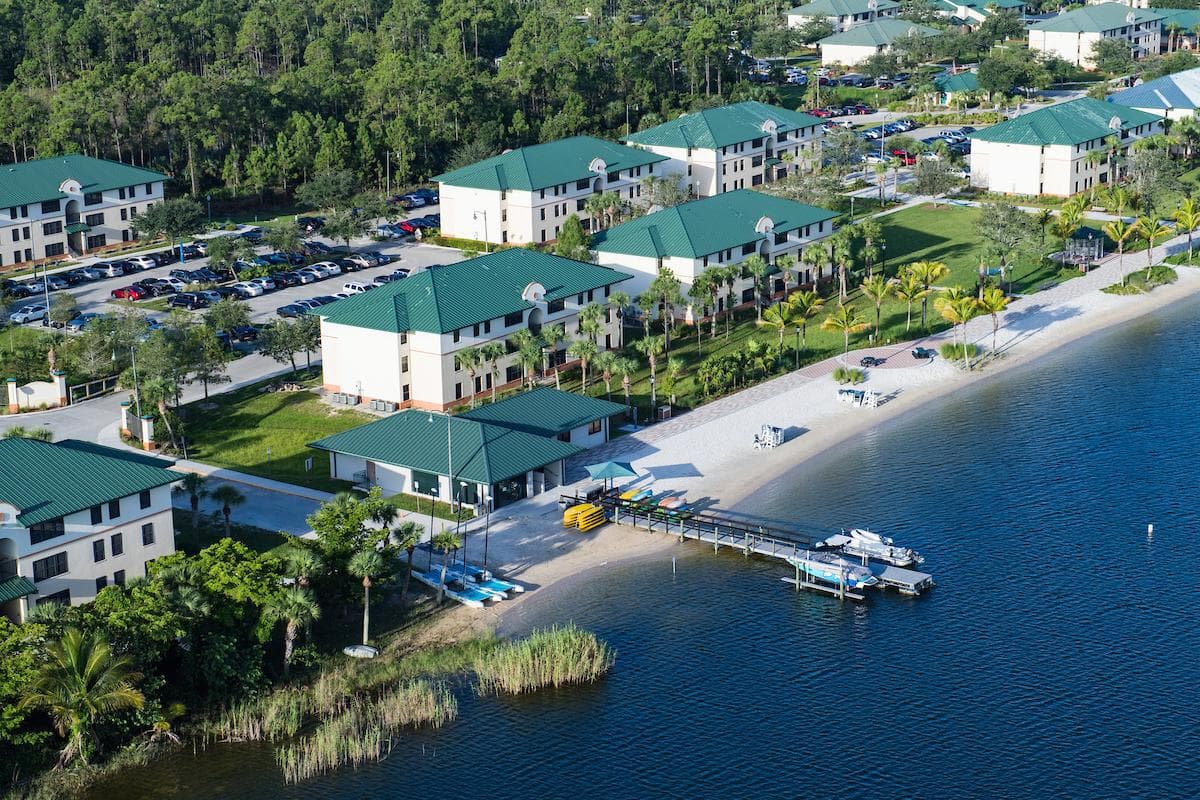 Florida Gulf Coast University Campus Aerial view of Florida Gulf Coast University campus located at the beach, showing buildings, palm trees and the water.
