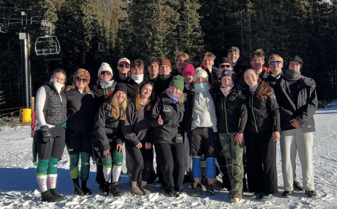 Plymouth State University Ski Team on the Slopes Plymouth State University ski team on snow in front of a chair lift.